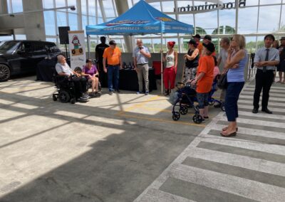 picture of attendees of MS road to a cure event with three people sitting on wheelchairs